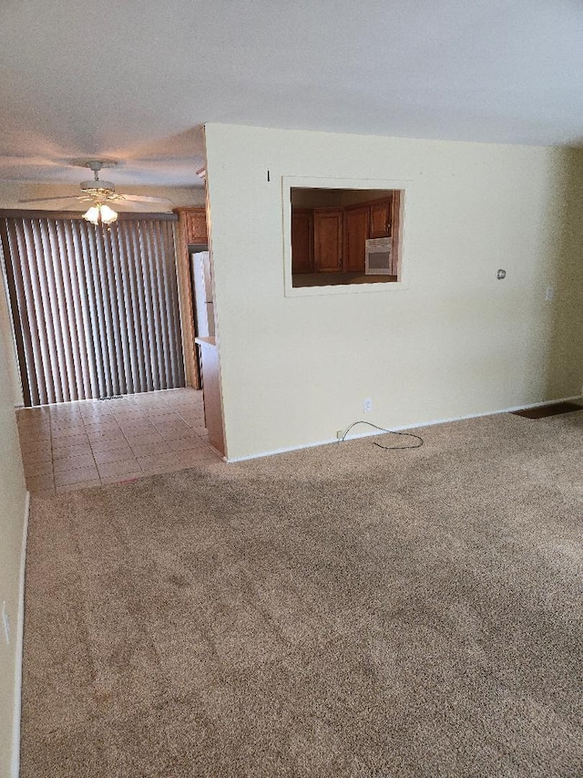 carpeted empty room featuring ceiling fan