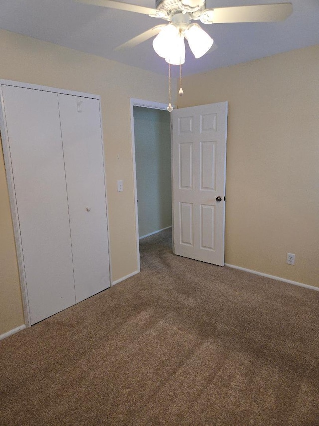 unfurnished bedroom featuring carpet flooring, ceiling fan, and a closet