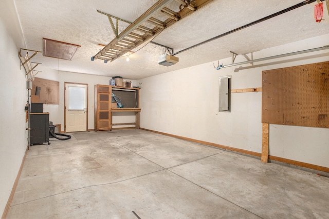 garage with electric panel and a garage door opener