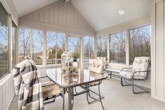 sunroom with vaulted ceiling and a healthy amount of sunlight