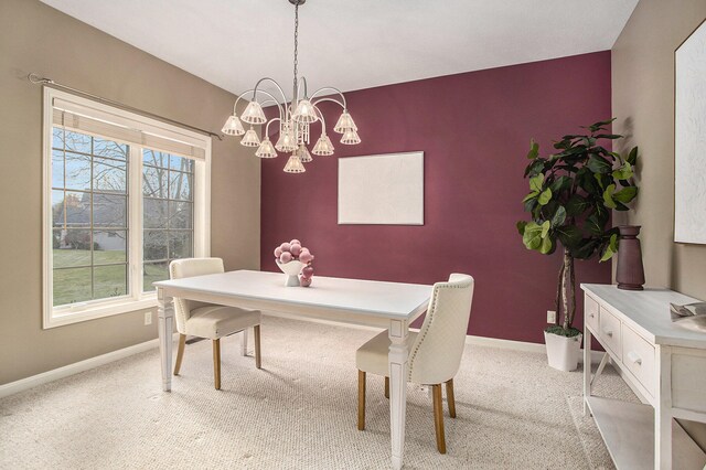 carpeted dining room featuring a chandelier