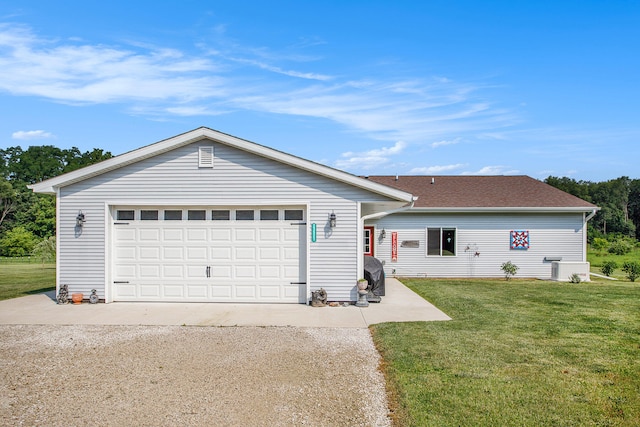 ranch-style house featuring a garage and a front lawn