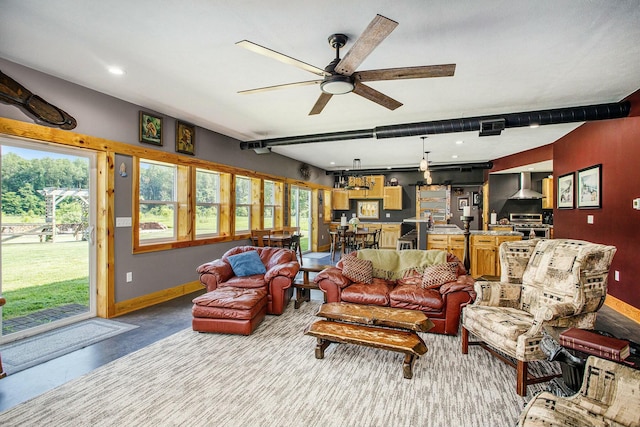 living room with ceiling fan and concrete flooring