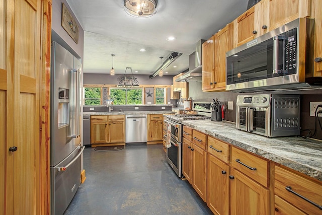 kitchen featuring wall chimney exhaust hood, tasteful backsplash, light stone counters, pendant lighting, and high quality appliances