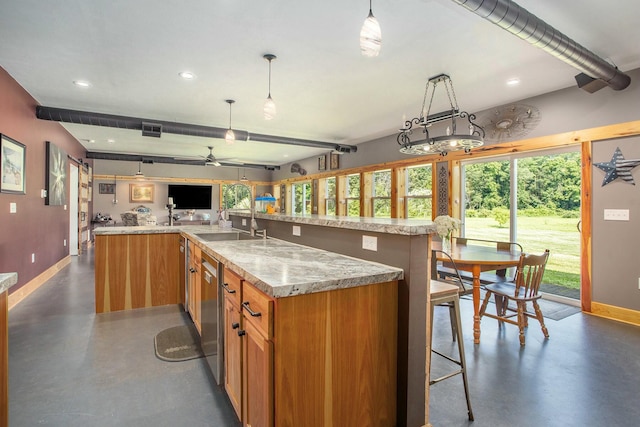 kitchen with ceiling fan, dishwasher, light stone counters, a large island with sink, and pendant lighting