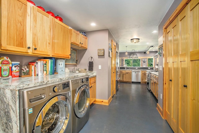 laundry room with washing machine and clothes dryer and sink