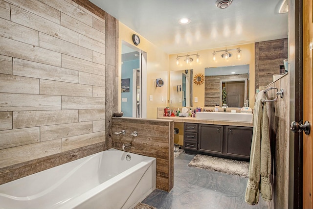 bathroom featuring vanity and a tub to relax in