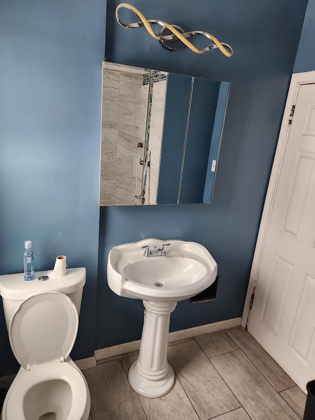 bathroom featuring hardwood / wood-style floors and toilet