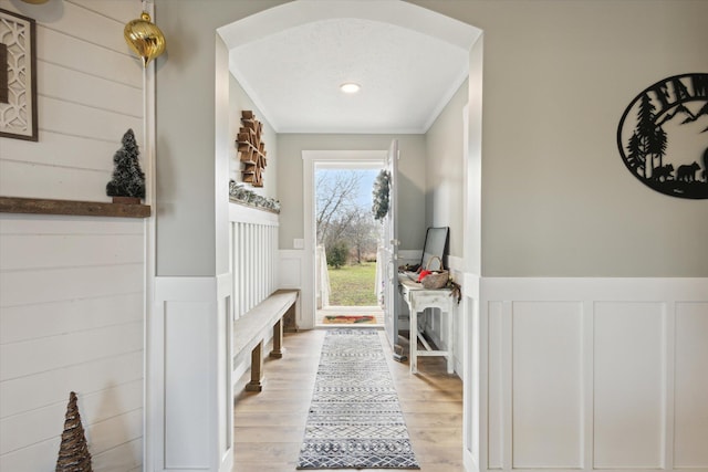 mudroom with light hardwood / wood-style floors and a textured ceiling