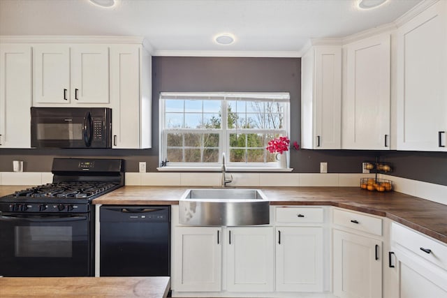 kitchen featuring sink, wooden counters, crown molding, white cabinets, and black appliances