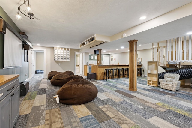 living room with bar area and a textured ceiling