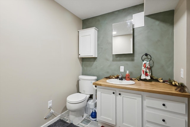 bathroom featuring tile patterned flooring, vanity, and toilet