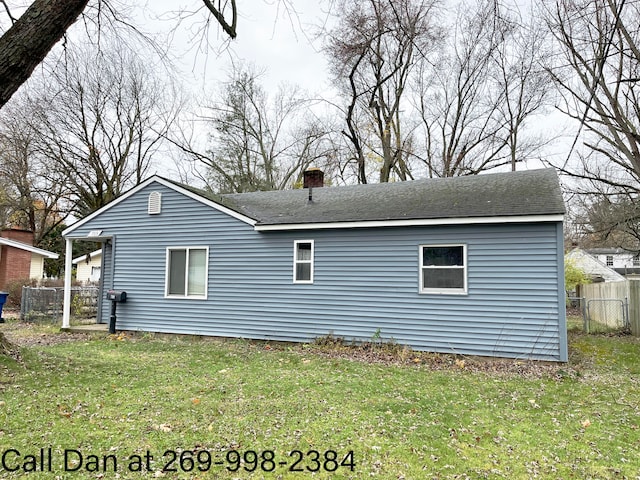 view of side of home with a lawn