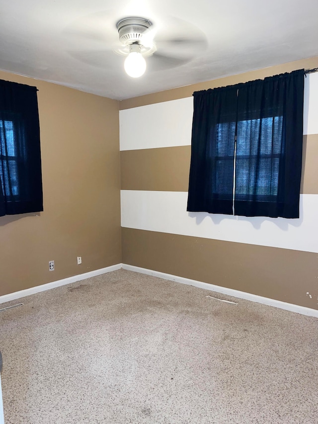 unfurnished room featuring baseboards