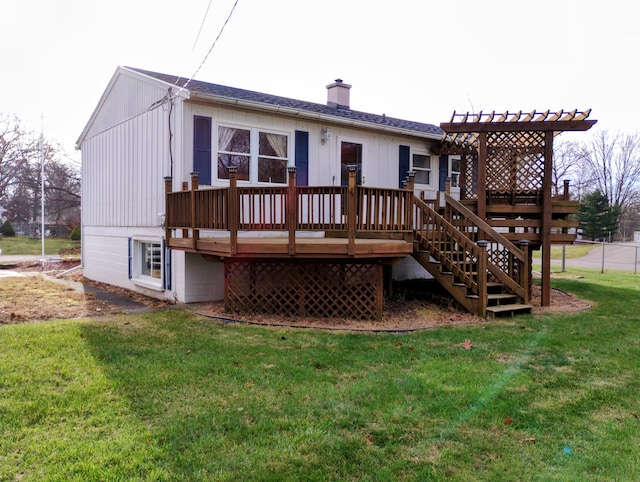 rear view of property with a lawn and a wooden deck