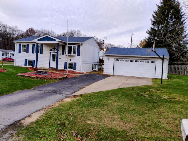 raised ranch featuring a garage and a front lawn