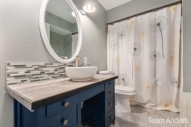 bathroom featuring tasteful backsplash, vanity, and toilet