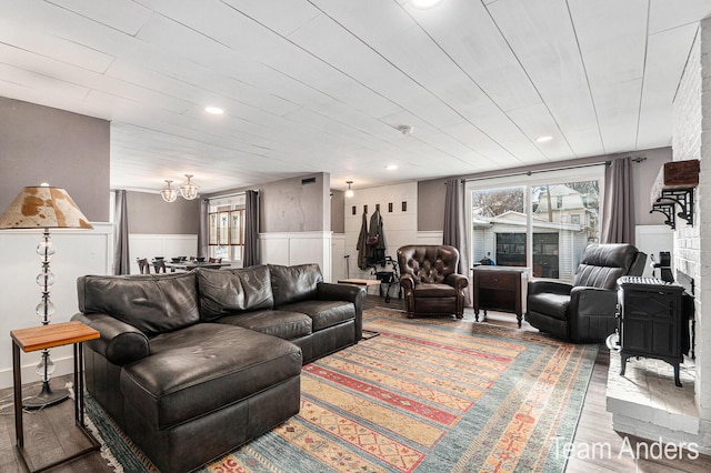 living room featuring wood-type flooring and a chandelier