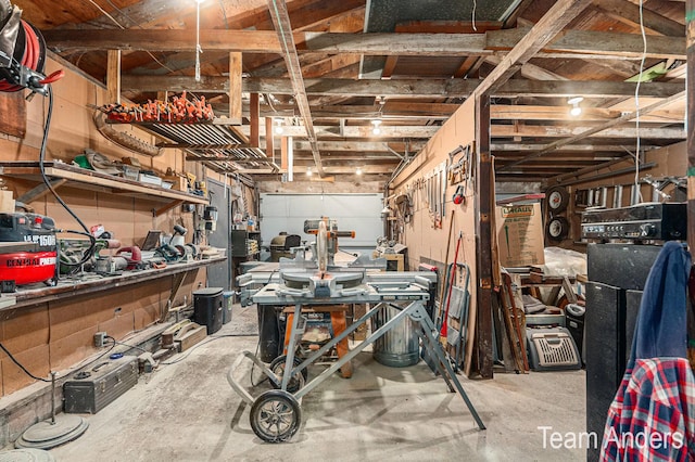 misc room with a workshop area and concrete flooring