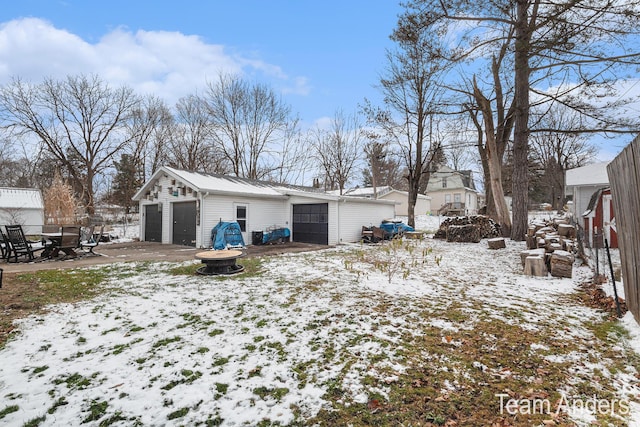 view of snow covered exterior featuring a garage