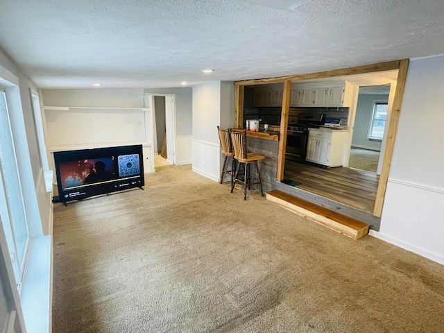 carpeted living room featuring a textured ceiling