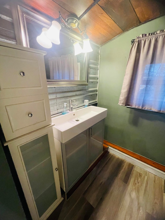 bathroom featuring vanity, wood ceiling, and hardwood / wood-style flooring