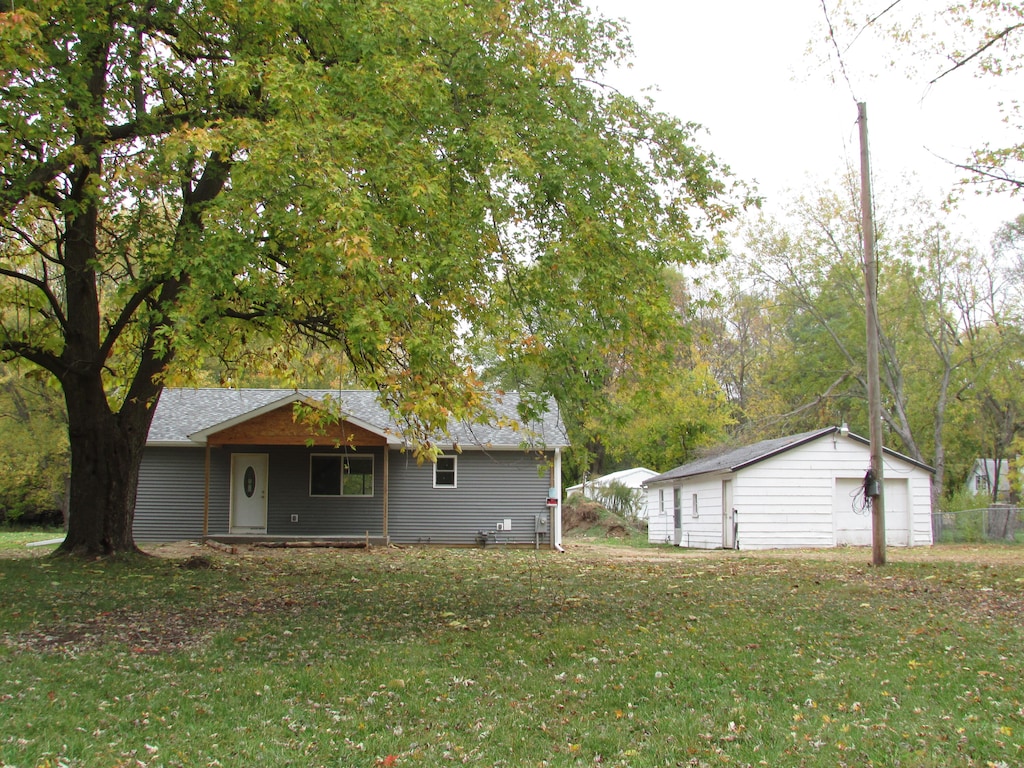 exterior space with a garage and an outdoor structure