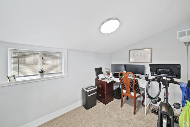 carpeted home office featuring lofted ceiling