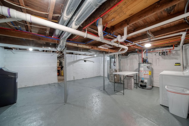 basement with washer and clothes dryer, gas water heater, and heating unit