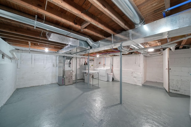 basement with washer and dryer and heating unit