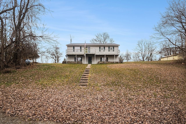 view of front of home featuring a front lawn and a deck