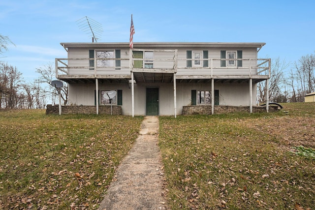 view of front facade with a front lawn and a wooden deck