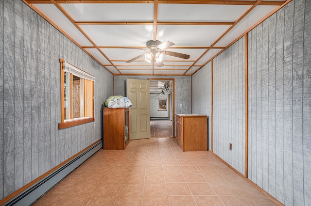 interior space featuring ceiling fan, light tile patterned floors, and a baseboard heating unit