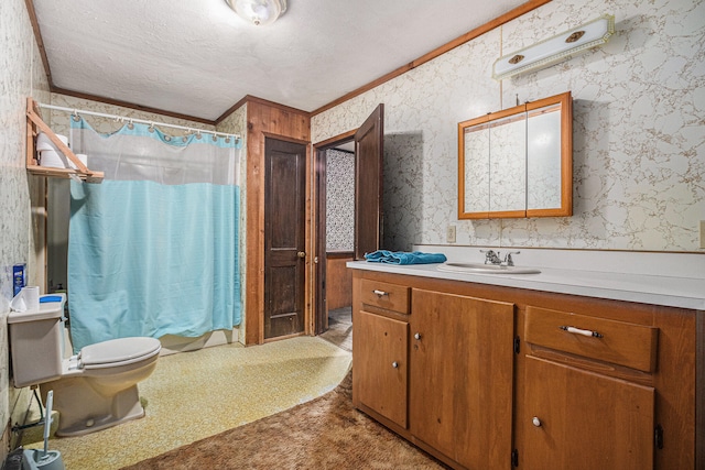 bathroom with vanity, crown molding, toilet, a textured ceiling, and curtained shower