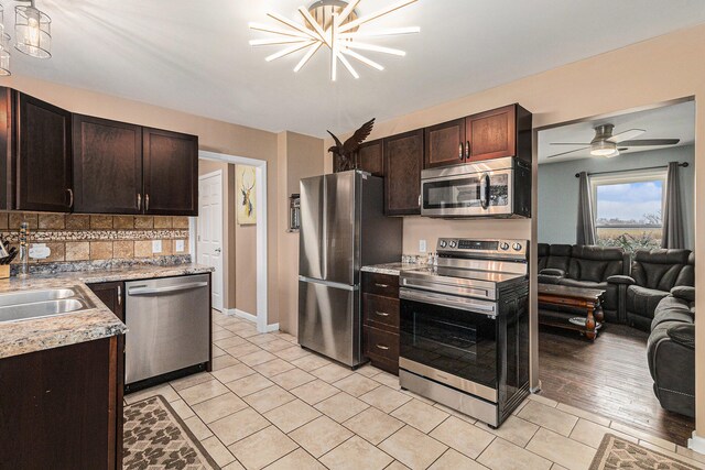 kitchen with tasteful backsplash, dark brown cabinets, light hardwood / wood-style floors, and appliances with stainless steel finishes