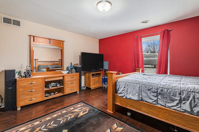 bedroom with dark hardwood / wood-style flooring