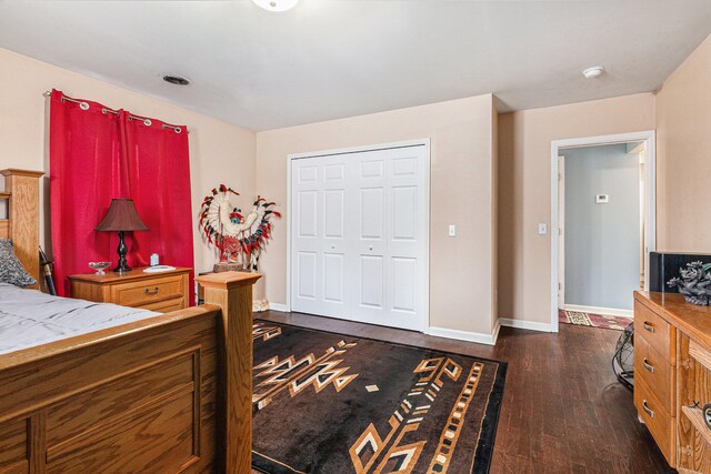 bedroom featuring a closet and dark hardwood / wood-style floors