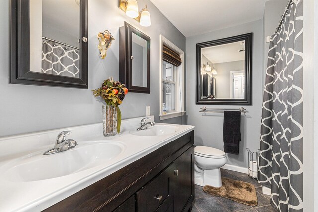 bathroom with tile patterned floors, vanity, and toilet