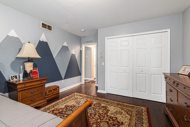 bedroom featuring a closet and dark wood-type flooring