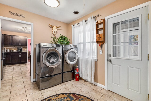 laundry area with light tile patterned floors and washer and dryer