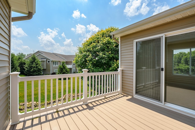 wooden terrace featuring a yard