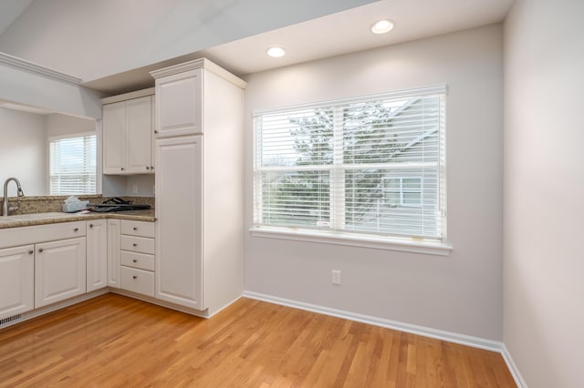 kitchen featuring sink, white cabinets, and light hardwood / wood-style floors