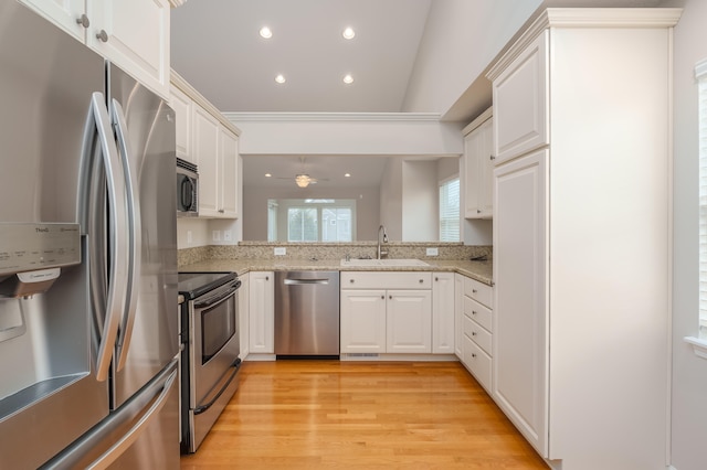 kitchen featuring sink, white cabinets, stainless steel appliances, and light wood-type flooring