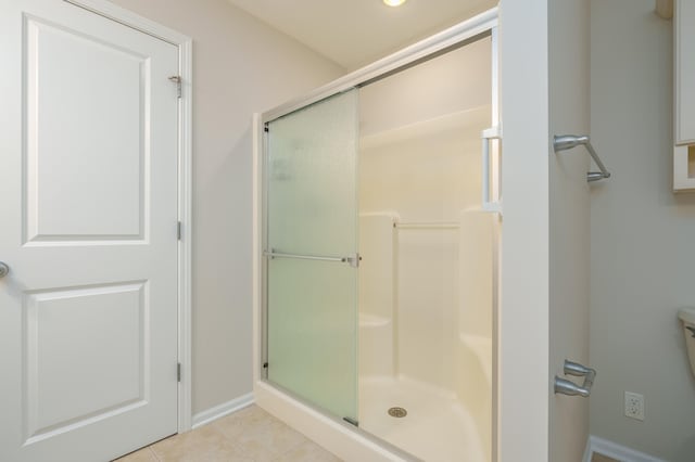 bathroom featuring tile patterned flooring and an enclosed shower