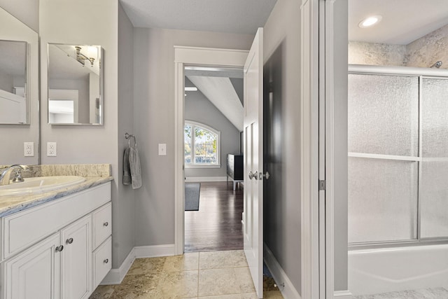 full bath with tile patterned floors, baseboards, and vanity