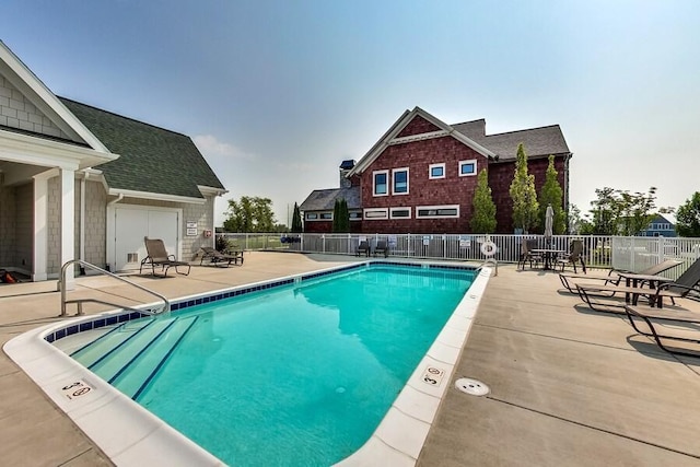 community pool featuring a patio area and fence