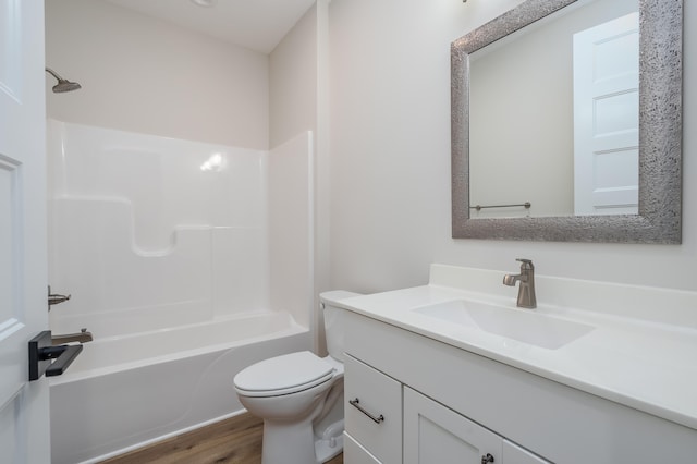 full bathroom with hardwood / wood-style flooring, vanity, toilet, and shower / washtub combination