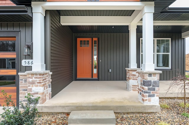 view of exterior entry with covered porch