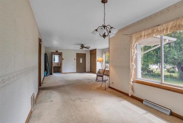 interior space featuring ceiling fan with notable chandelier