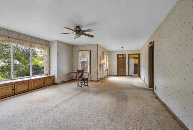 carpeted empty room with ceiling fan